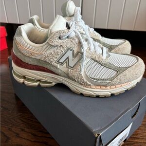 New Balance 2002R Cream and Gray Sneakers with Red Accents